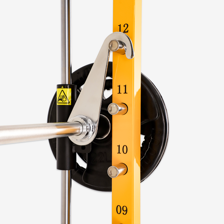 Close-up of a mechanical device with a yellow scale and metal components on a white background