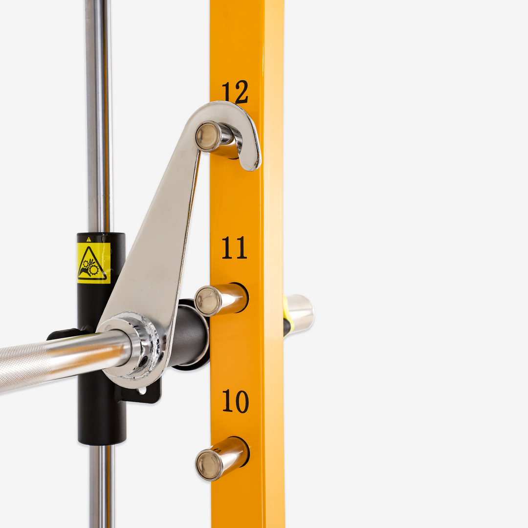 Gym equipment with a pulley system and numbered yellow bar