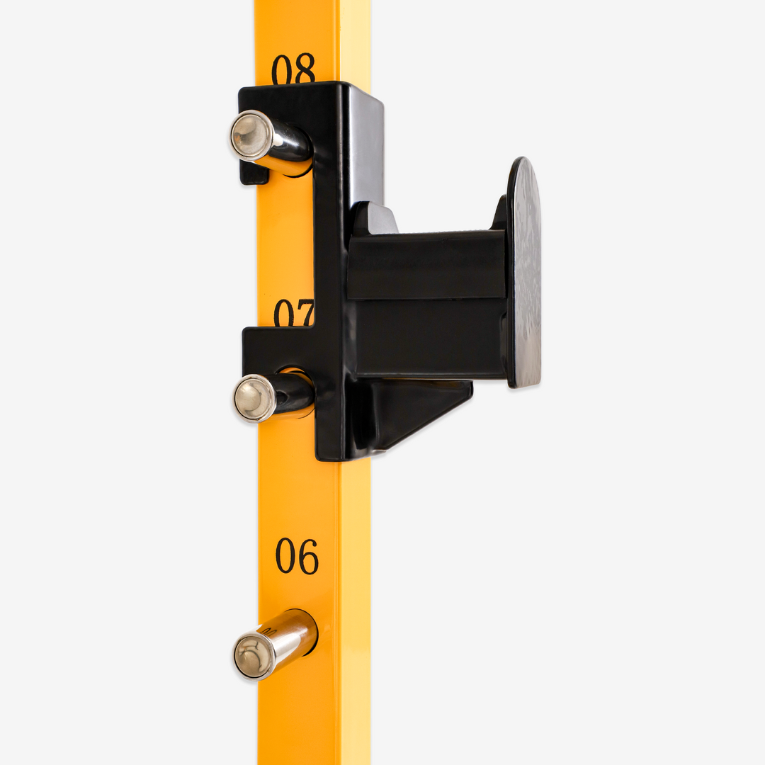 Yellow rod with black clamp and numbered markings on a white background