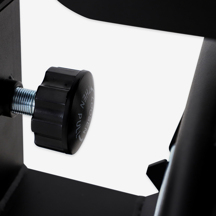 Close-up of a black knob on a mechanical device with a white background