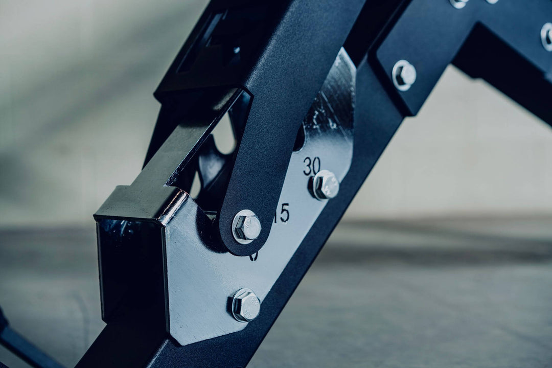Close-up of adjustable bench mechanism showing settings for personalized weight adjustments.