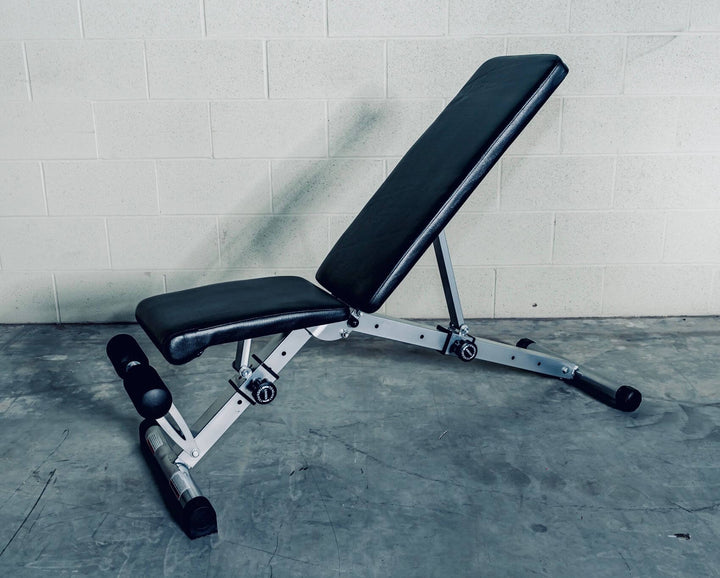 Adjustable bench XRAB02 X-RIVAL in incline position for versatile workouts, suitable for barbells and dumbbells.